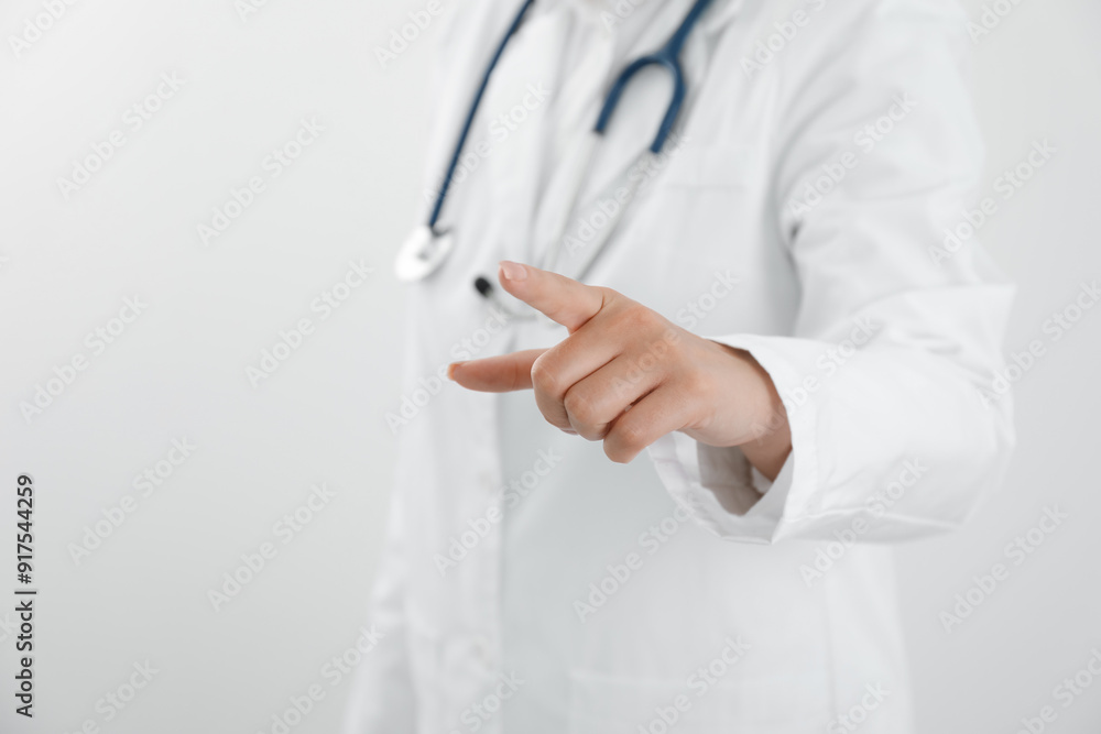 Doctor pointing at something on white background, closeup. Space for text Doctor pointing at something on white background, closeup. Space for text