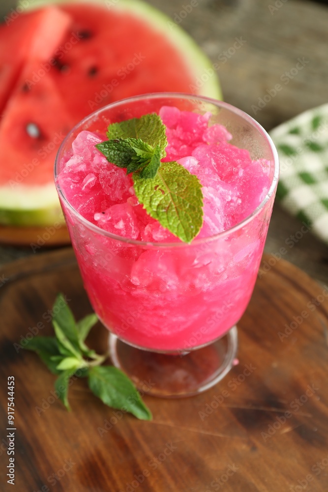 Tasty watermelon sorbet in glass dessert bowl and mint on table, closeup Tasty watermelon sorbet in glass dessert bowl and mint on table, closeup