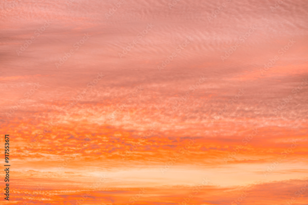 Obraz premium A beautiful sky tinted by the sun leaving vibrant shades of gold, pink, blue and multicolored. Clouds in the twilight evening and morning sky. Cloudy sky background in the evening and during the day.