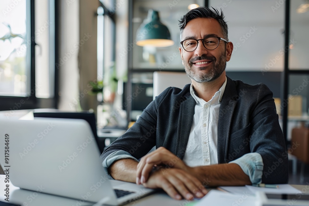 The image portrays the essence of a successful businessman in a contemporary office environment. The image portrays the essence of a successful businessman in a contemporary office environment.