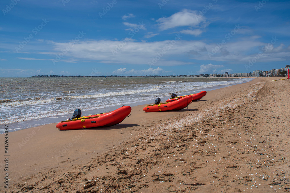 Red inflatable boat on a beach in Brittany in summer in France Red inflatable boat on a beach in Brittany in summer in France