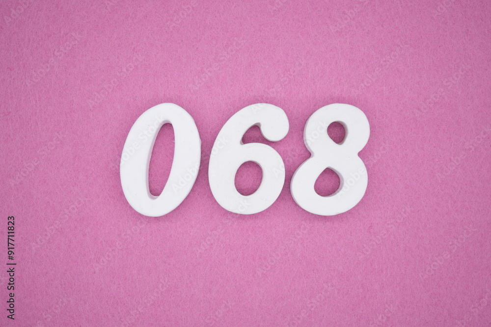 The numbers are made of white painted wood. Laying on the floor was pink paper. The numbers are made of white painted wood. Laying on the floor was pink paper.
