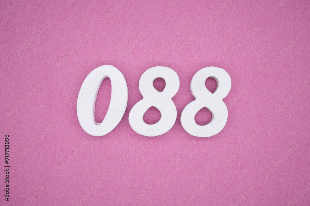 The numbers are made of white painted wood. Laying on the floor was pink paper. The numbers are made of white painted wood. Laying on the floor was pink paper.
