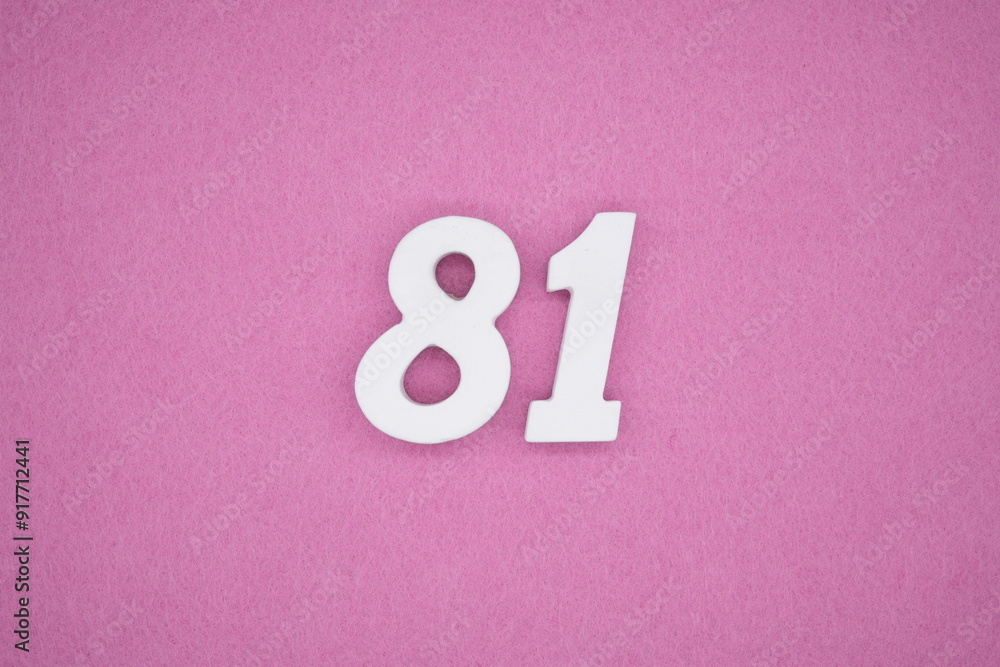 The numbers are made of white painted wood. Laying on the floor was pink paper. The numbers are made of white painted wood. Laying on the floor was pink paper.