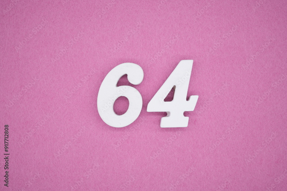 The numbers are made of white painted wood. Laying on the floor was pink paper. The numbers are made of white painted wood. Laying on the floor was pink paper.