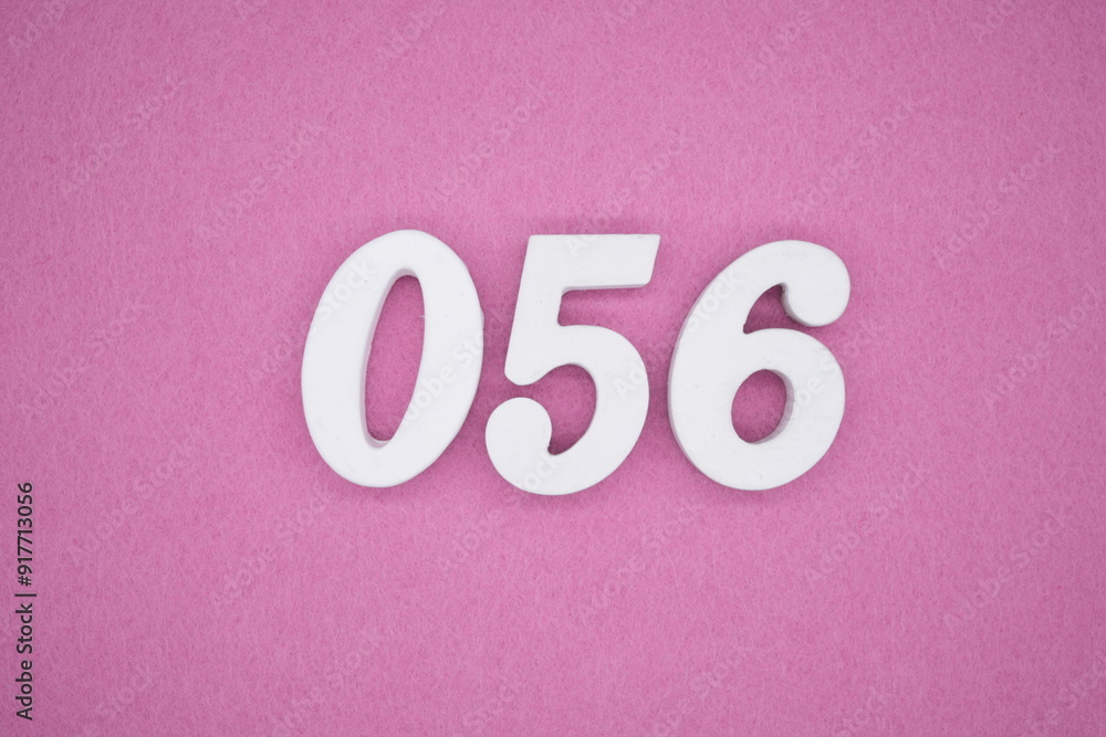 The numbers are made of white painted wood. Laying on the floor was pink paper. The numbers are made of white painted wood. Laying on the floor was pink paper.