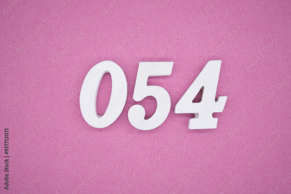 The numbers are made of white painted wood. Laying on the floor was pink paper. The numbers are made of white painted wood. Laying on the floor was pink paper.