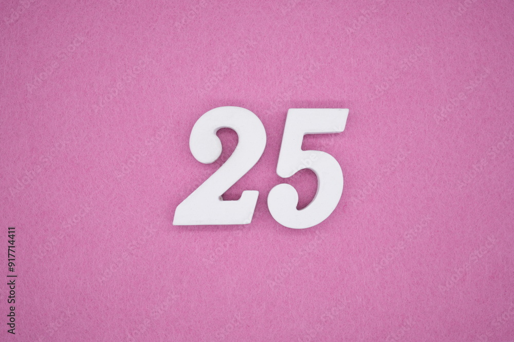 The numbers are made of white painted wood. Laying on the floor was pink paper. The numbers are made of white painted wood. Laying on the floor was pink paper.