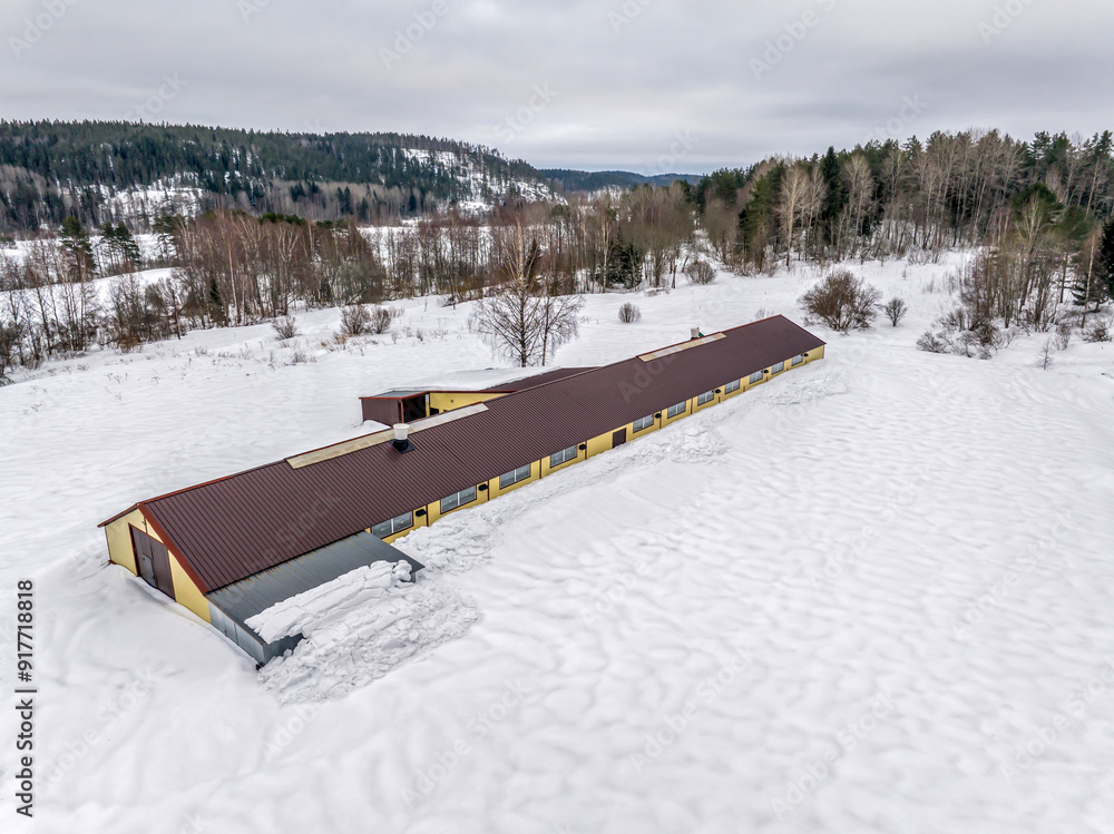 Aerial photo of forest, lake and agricultural land in the winter. Aerial view of non-working Livestock farm in Karelia