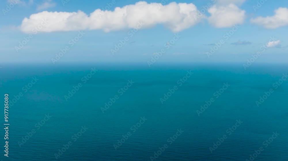 Blue sea surface under blue sky and clouds. Santa Fe, Tablas, Romblon. Philippines. Blue sea surface under blue sky and clouds. Santa Fe, Tablas, Romblon. Philippines.