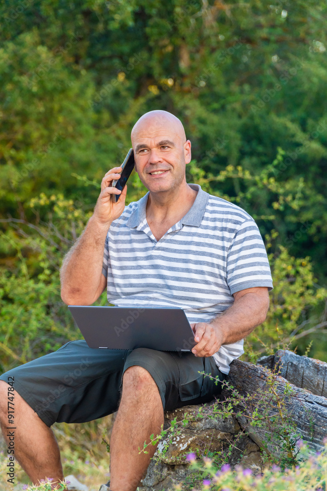 Man working in nature with a laptop, digital nomad concept. Man working in nature with a laptop, digital nomad concept.