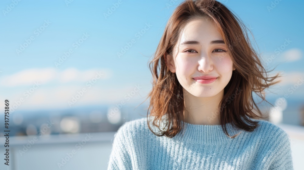 Smiling woman in blue sweater with outdoor background Smiling woman in blue sweater with outdoor background