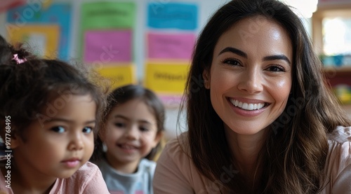Smiling Hispanic Teacher Engaging with Diverse Preschool Children in Classroom