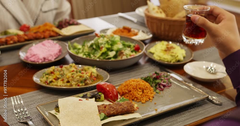 People sit at a table in a restaurant and eat People sit at a table in a restaurant and eat
