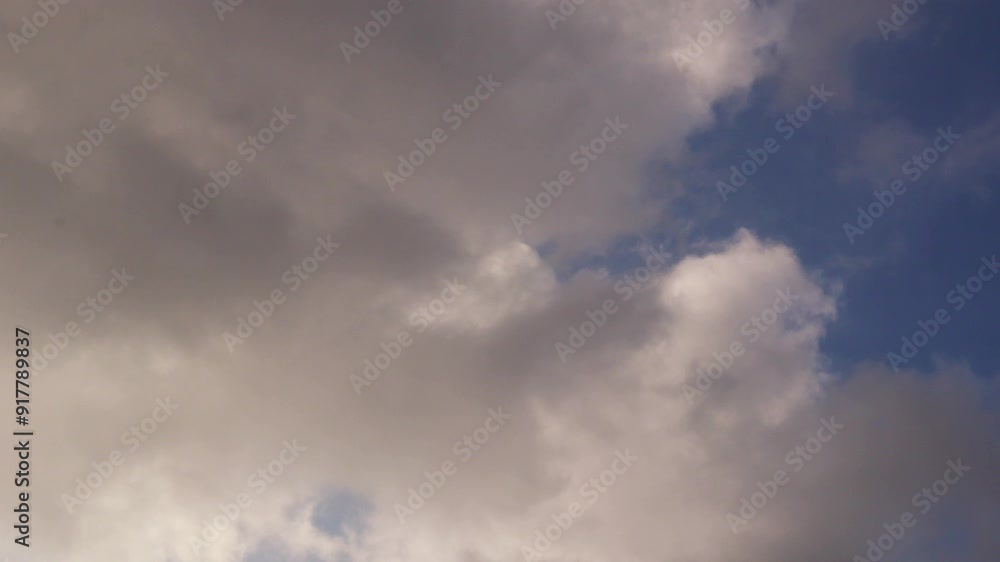 Time lapse video of rain clouds moving in a blue sky Time lapse video of rain clouds moving in a blue sky