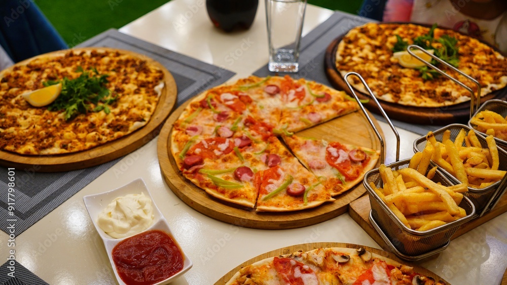 Pizza and Fries on Table Pizza and Fries on Table