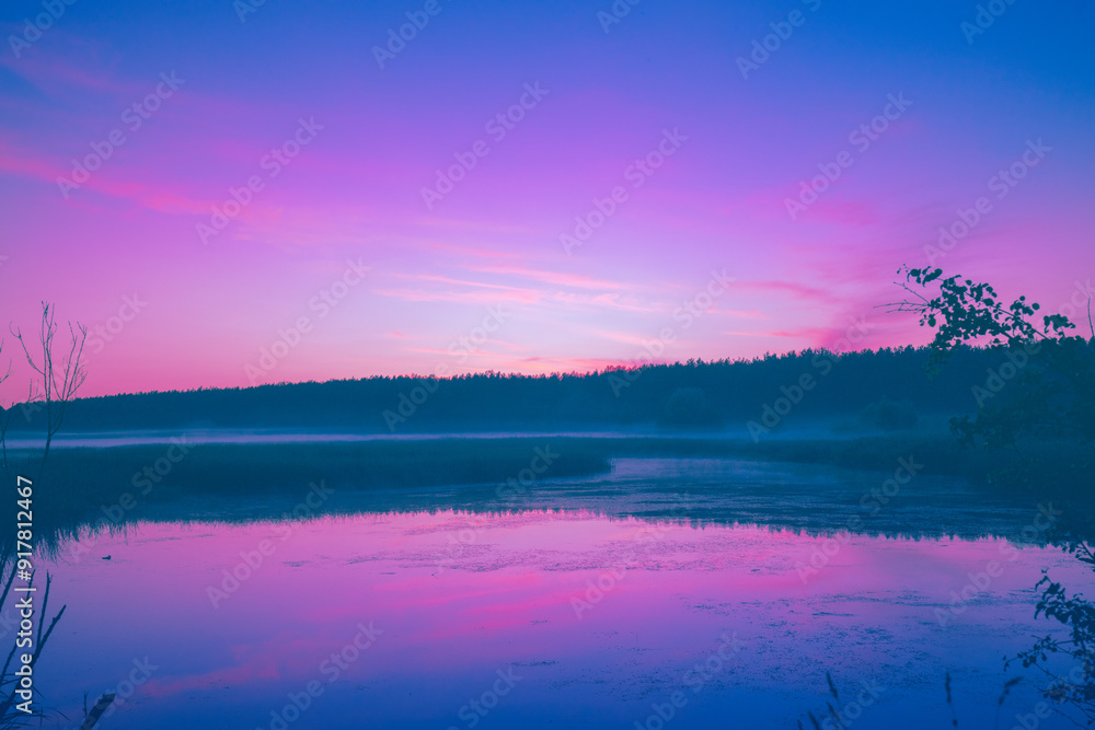 Fototapeta premium Magical sunrise over the lake. Misty early morning. Serenity lake in magical light