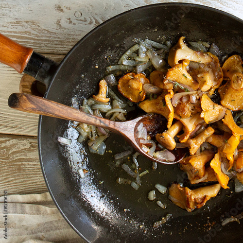 cast iron frying pan with fried chanterelles on the table