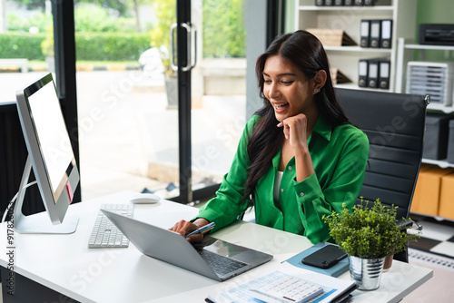 Business women hand working with tablet and laptop computer with documents on office desk in modern office.