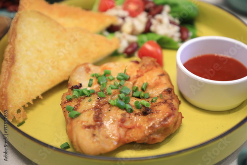 Grilled chicken breast served with crispy French fries, a fresh salad, and a side of tangy barbecue sauce is perfect for food lovers and culinary enthusiasts.