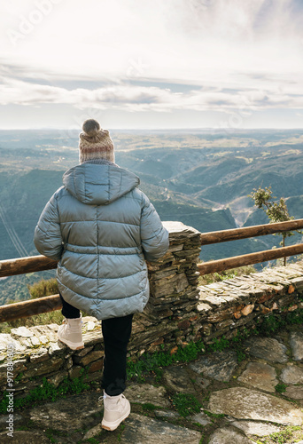 Back view of anonymous person enjoying view at Cachon del Camaces photo