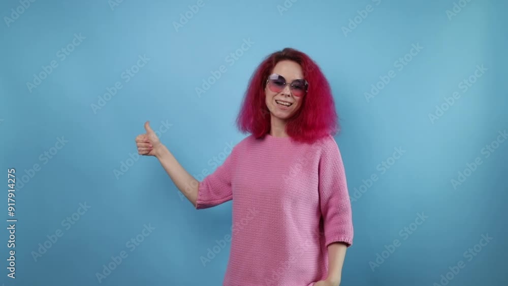woman with pink hair showing thumbs up, young student with curly hair, joyful expression and cool style. woman with pink hair showing thumbs up, young student with curly hair, joyful expression and cool style.