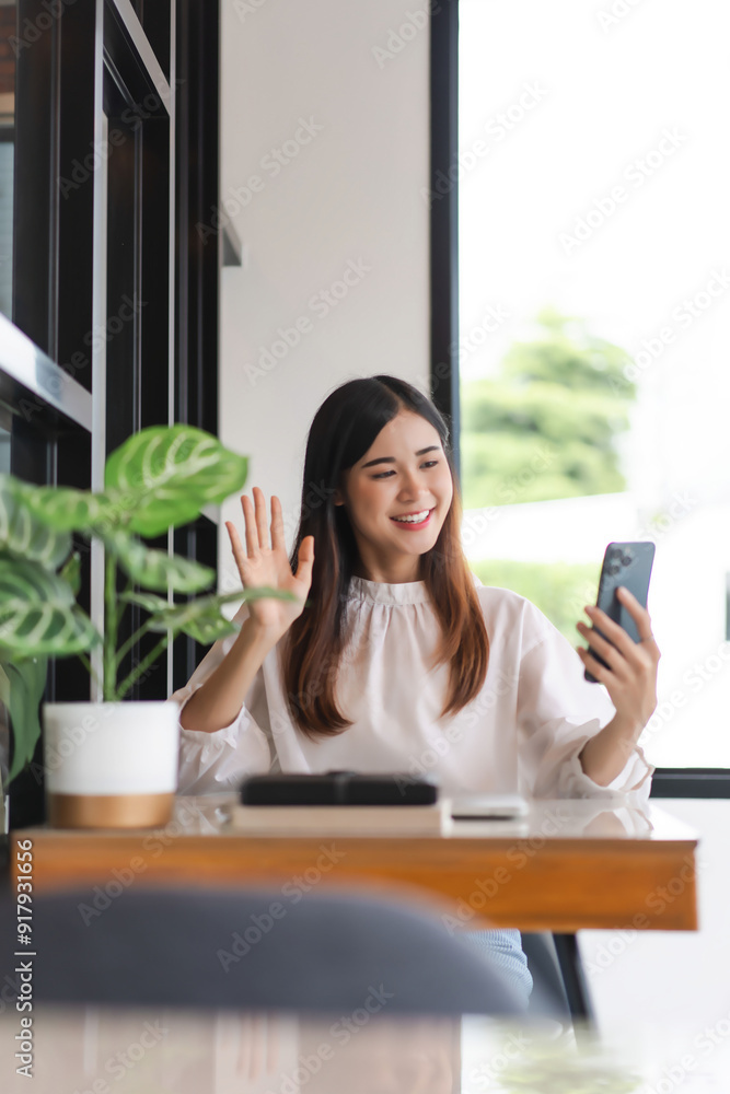 Businesswomen use smartphone to greeting with colleague in video call and working in outside office Businesswomen use smartphone to greeting with colleague in video call and working in outside office