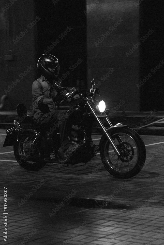a man on a red chopper motorcycle. guy on a bike at night. a man on a red chopper motorcycle. guy on a bike at night.