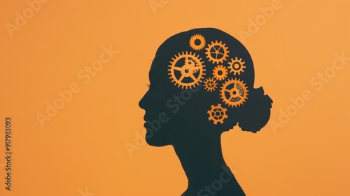 Silhouette of a woman's profile with gears, symbolizing creativity, innovation, and mental processes against an orange background. photo