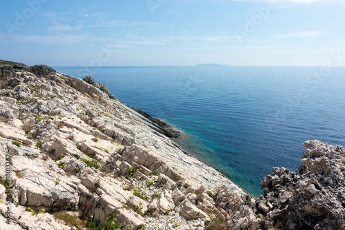 Amazing rocky formations and gorgeous sea waters of the south coastline in Othonoi island, Greece photo