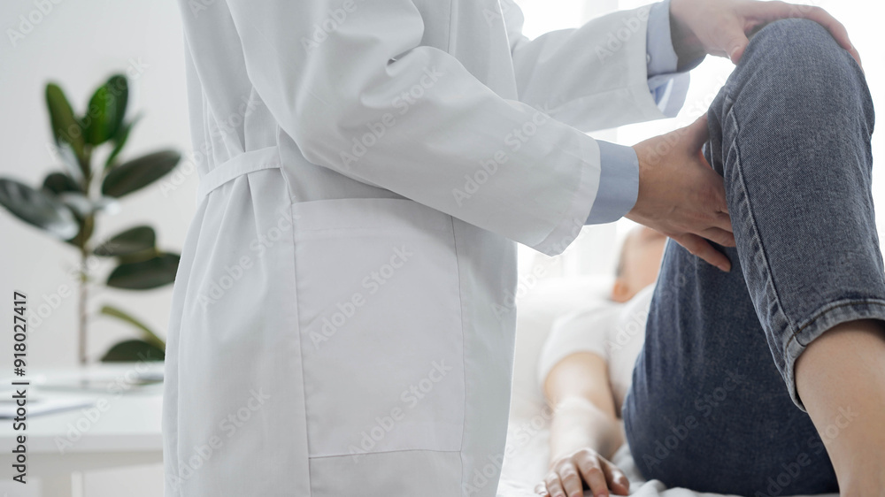 Doctor and patient are at the medical inspection in clinic. Orthopedic examines the knee of a young woman. Medicine concept Doctor and patient are at the medical inspection in clinic. Orthopedic examines the knee of a young woman. Medicine concept