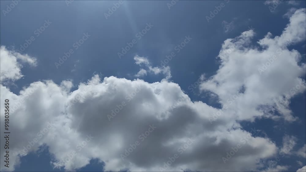 Very large white clouds moving at midday