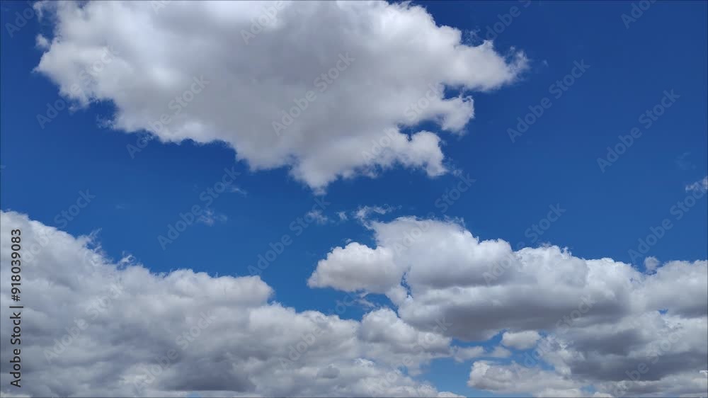 Whitish or greyish clouds move across the sky at midday Whitish or greyish clouds move across the sky at midday