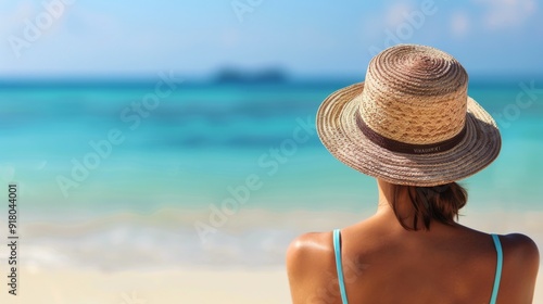 Relaxing Woman in Straw Hat by the Turquoise Ocean at a Tropical Beach