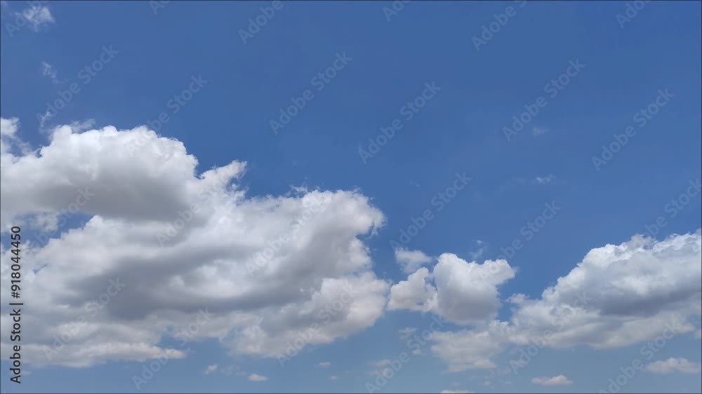 Dense whitish clouds moving across the sky at midday Dense whitish clouds moving across the sky at midday