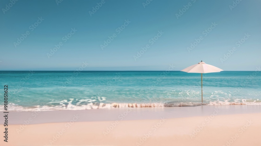 Fototapeta premium White Umbrella on Sandy Beach With Turquoise Water Under Clear Sky
