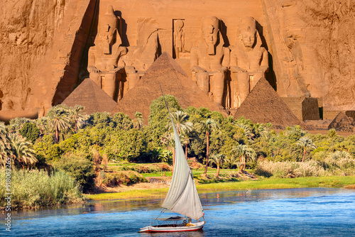 Beautiful Nile scenery with traditional Felluca sailing boat in the Nile on the way to Giza pyramids - Beautiful Nile scenery with sailboat in the Nile on the way to The Front of the Abu Simbel Temple photo