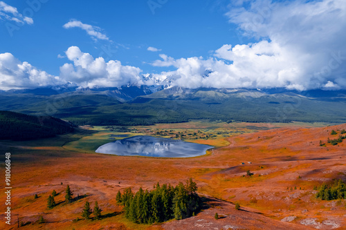 Autumn landscape Altai yellow forest crystal clear lake Dzhangyskol and snowy mountain peaks, aerial view. photo