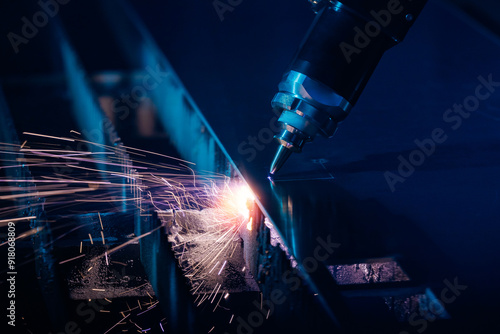 Obraz na plátne Bevel cutting metal from CNC laser, sparks fly