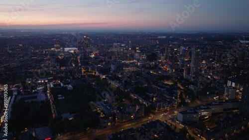 Wallpaper Mural Aerial view of Rotterdam cityscape at dusk. Vibrant architectural landscape with illuminated skyscrapers and streets defining the urban environment Torontodigital.ca