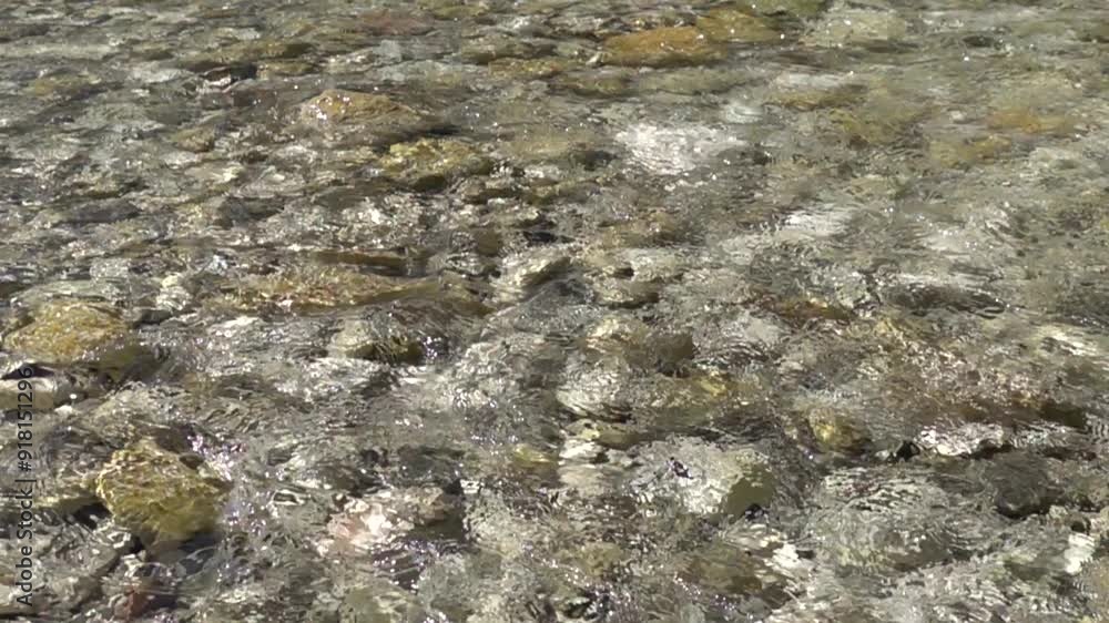 Crystal clear mountain river flowing over stone riverbed, slow motion footage Crystal clear mountain river flowing over stone riverbed, slow motion footage