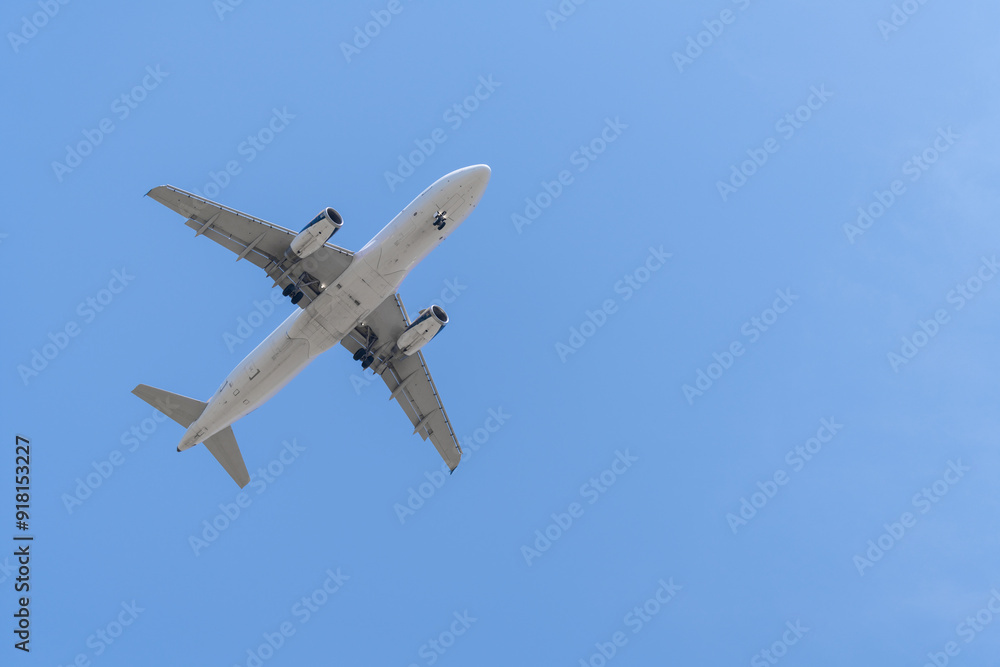 Landing airplane on the background of blue sky Landing airplane on the background of blue sky