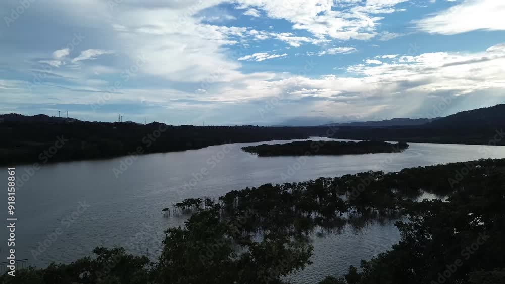 Mangrove trees that line the banks of a large, murky river provide a sanctuary for migratory birds. Drone aerial Mangrove trees that line the banks of a large, murky river provide a sanctuary for migratory birds. Drone aerial