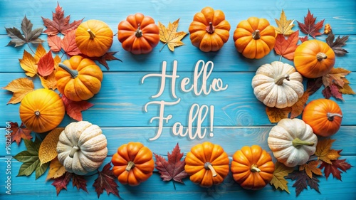 Pumpkins and Autumn Leaves on Blue Wooden Background.