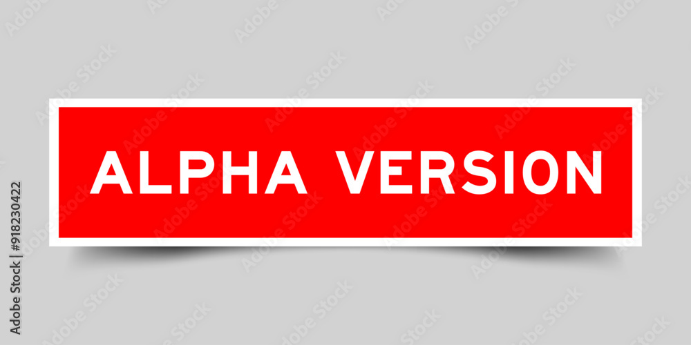 Square sticker label with word alpha version in red color on gray background Square sticker label with word alpha version in red color on gray background