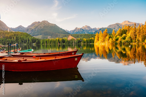 Red boats on Mountain lake Strbske pleso. Strbske lake with view of the High Tatras National Park, Slovakia photo