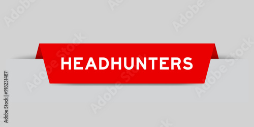 Red color inserted label with word headhunters on gray background
