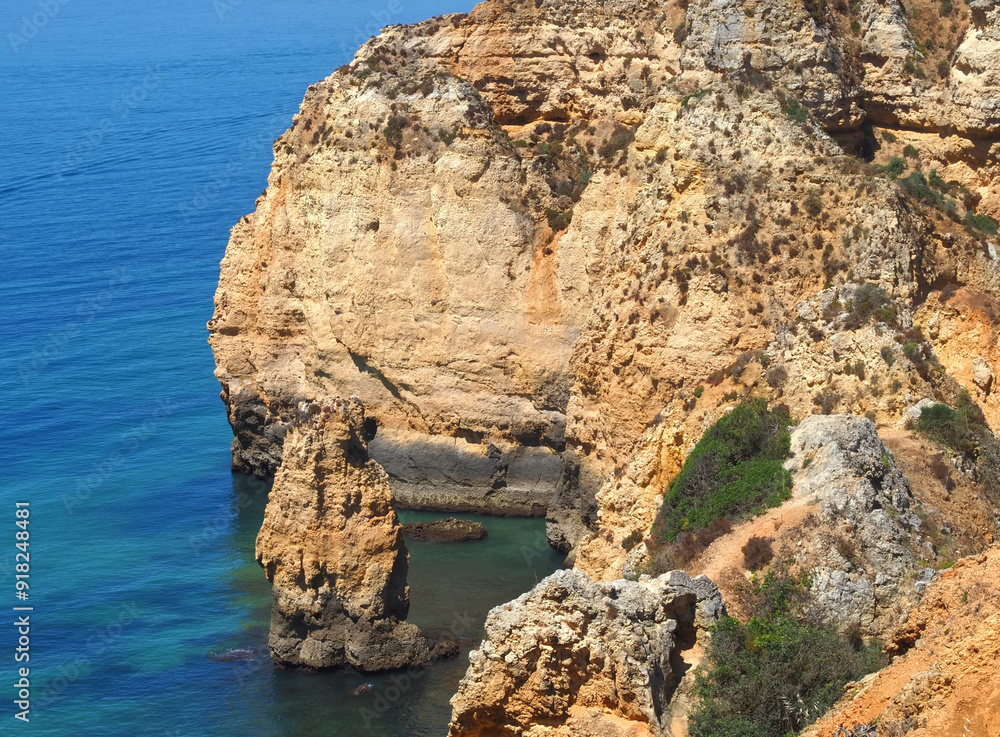 Fototapeta premium Algarve coast of Portugal between Ponta da Piedade and beach Praia Porto de Mos in Lagos with epic cliffs and nature