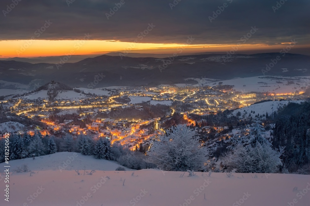 Blue winter morning in old romantic city. Wonderful, romantic winter mood in the city. Beautiful Christmas wallpaper. Winter night in Banska Stiavnica Blue winter morning in old romantic city. Wonderful, romantic winter mood in the city. Beautiful Christmas wallpaper. Winter night in Banska Stiavnica