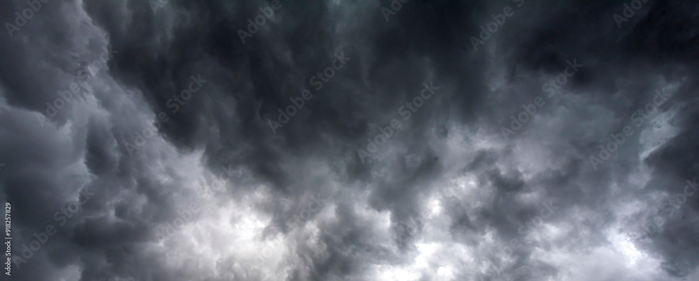 Obraz premium Banner Dramatic dark storm clouds black sky background. Dark thunderstorm clouds rainny season. Panorama Meteorology danger windstorm disasters climate. Dark cloudscape storm cloud with copy space.